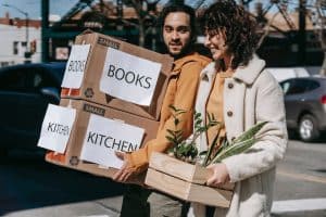 A couple carrying boxes